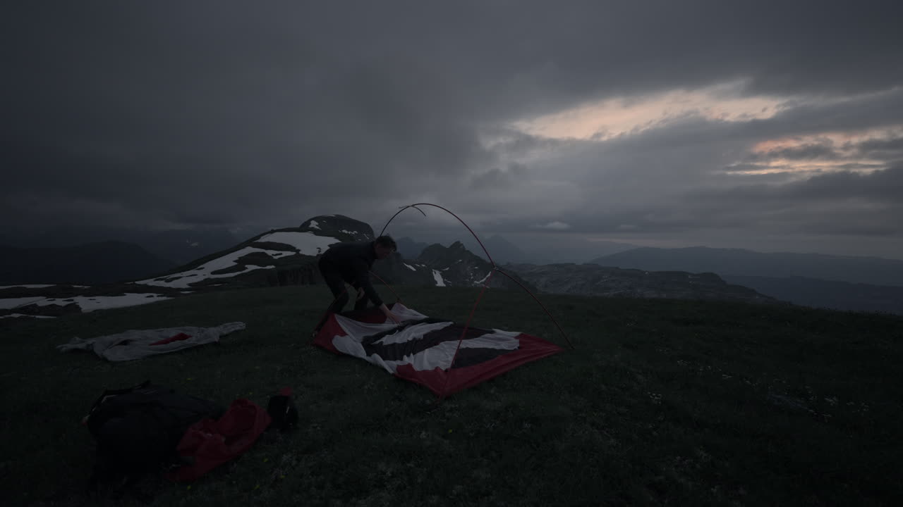 Setting up Tent in the Mountains at Dusk