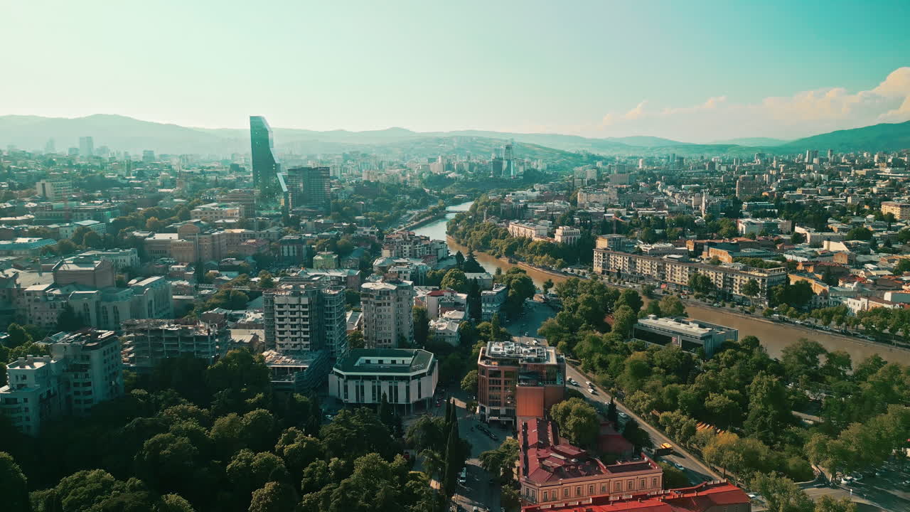 Aerial View of Tbilisi City with River and Mountains