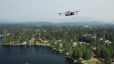 drone camera hovering over pipe lake with green coniferous trees in washington, usa