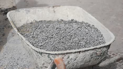 loading gravel into wheelbarrow
