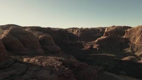 Aerial-view-showcasing-the-rugged-and-desolate-beauty-of-landscapes-in-Utah,-USA,-capturing-the-concept-of-nature's-raw-and-untamed-majesty