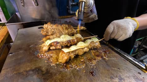 cooking and basting skewers on a hot grill