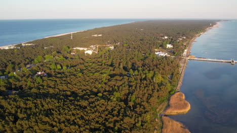 Aerial-Slow-Descending-Revealing-Jurata-Town-Bay-on-Hel-Peninsula-Coastline,-Poland