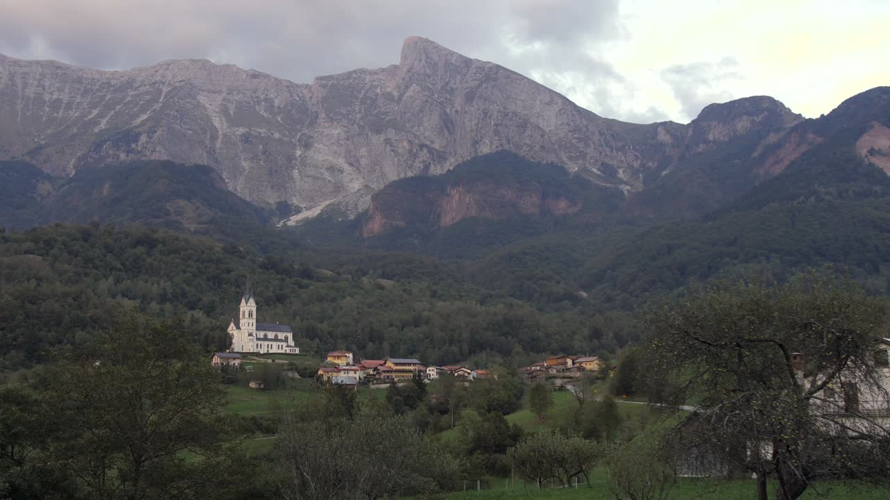 Dreznica village below majestic mountain Krn in julian alps, autumn evening pan