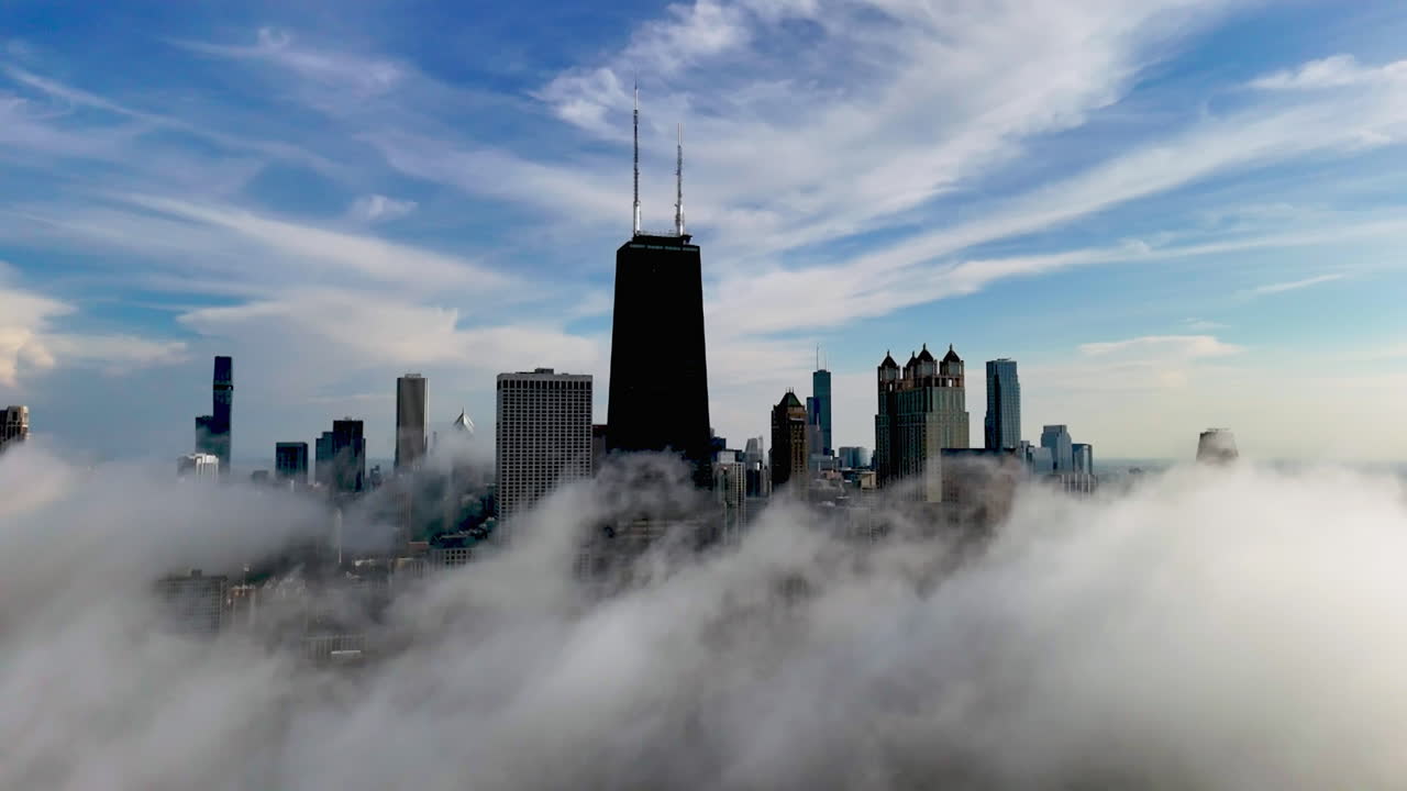 Aerial hyperlapse rotating away from the foggy Streeterville skyline in Chicago
