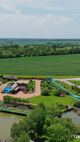 aerial view of a water park with a waterslide and surrounding landscape