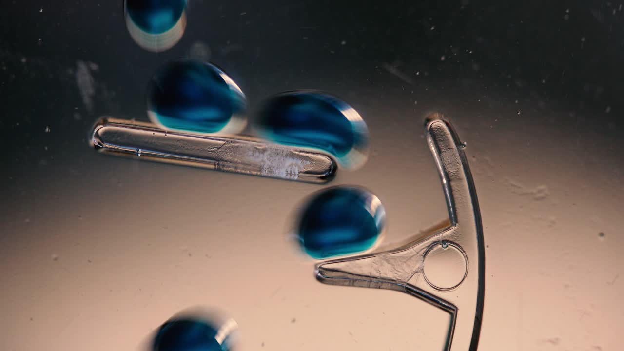 Inky Chemical Drops Sliding Down Ramps