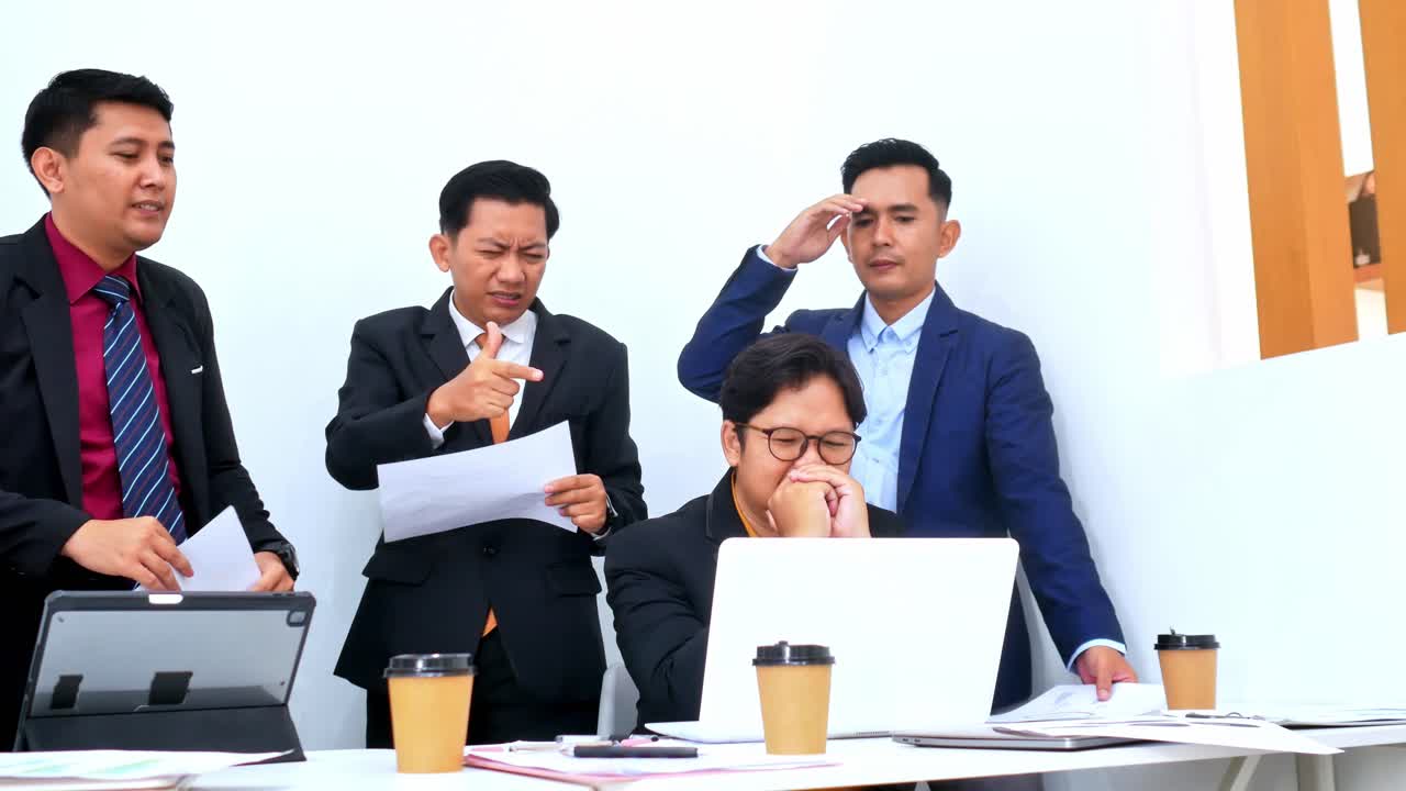 Frustrated team in meeting struggles with difficult project showing stress and pressure