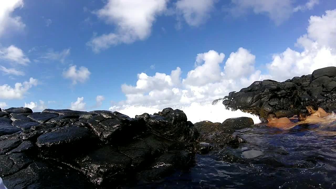 Ocean water splashing into camera in Queen's bath, Kau'i Hawai'i.