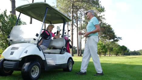 Male-golf-player-interacting-with-woman