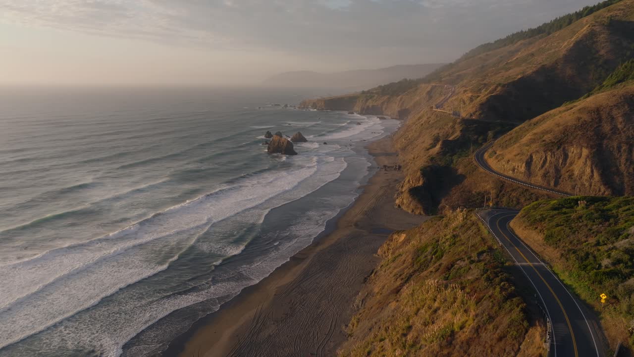 Serene aerial view of winding California Coast Hwy 1 at golden hour