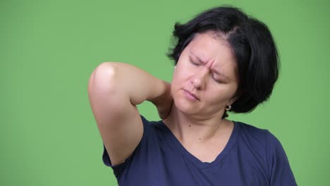Stressed woman with short hair having neck pain