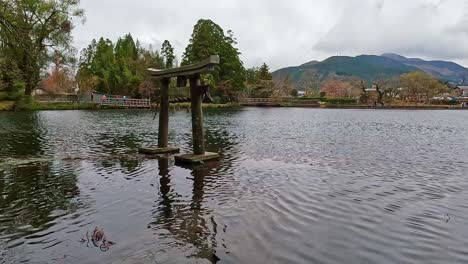 stone torii gate standing in a lake