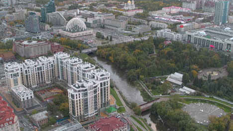 cityscape aerial view with river, park, and buildings