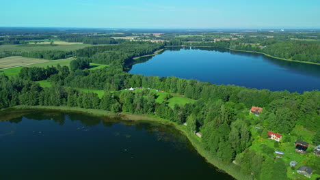 Scenic-Aerial-Drone-Shot-Over-Lakes-and-Campsite-in-Latvia-with-Green-Countryside-Views