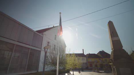 arcing shot of a french flag beside a monument