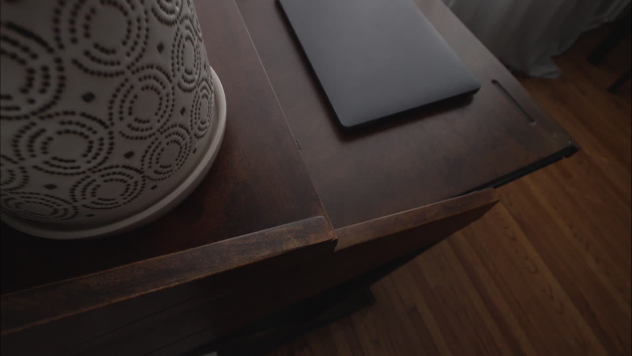 Steadicam reveal of home office with modern decor and laptop on desk