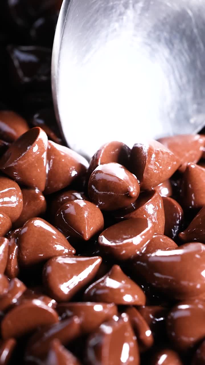 Spoon moving through a pile of chocolate chips