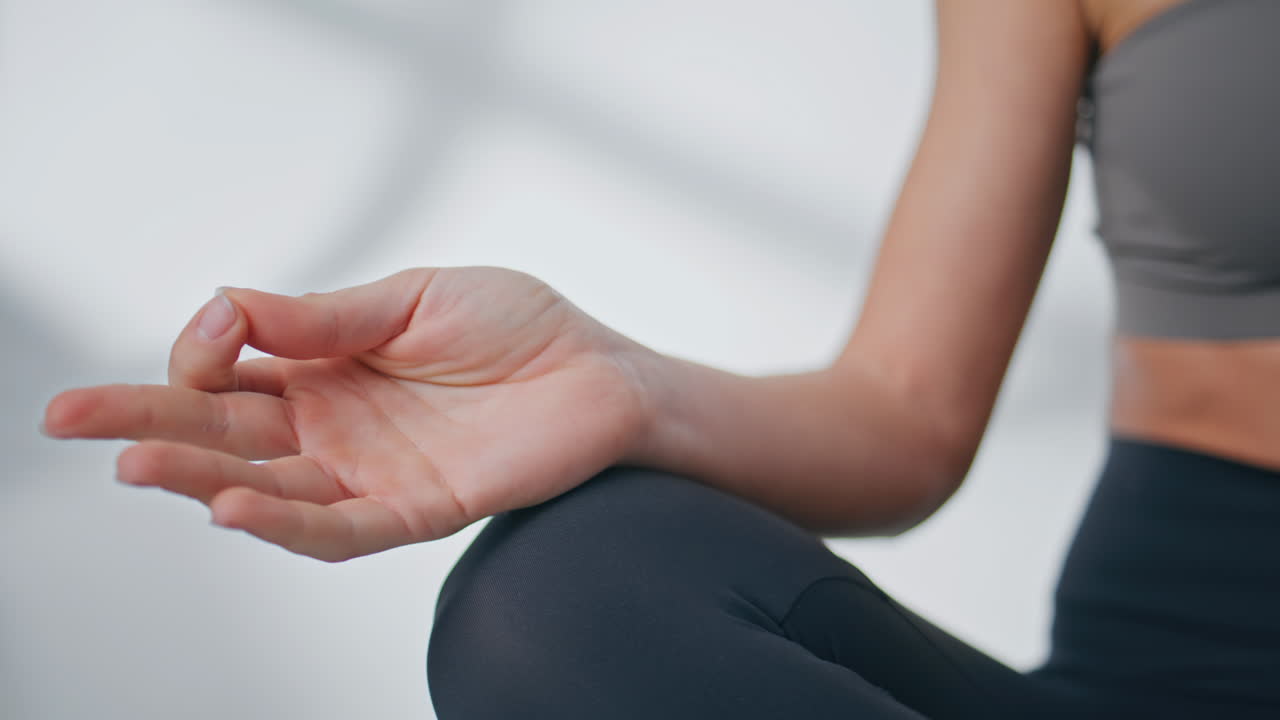 Woman hands making yoga position training spiritual practices indoors closeup