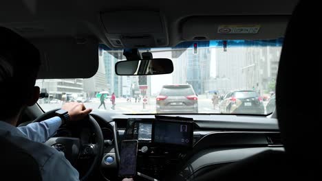 driver navigates traffic in dubai cityscape