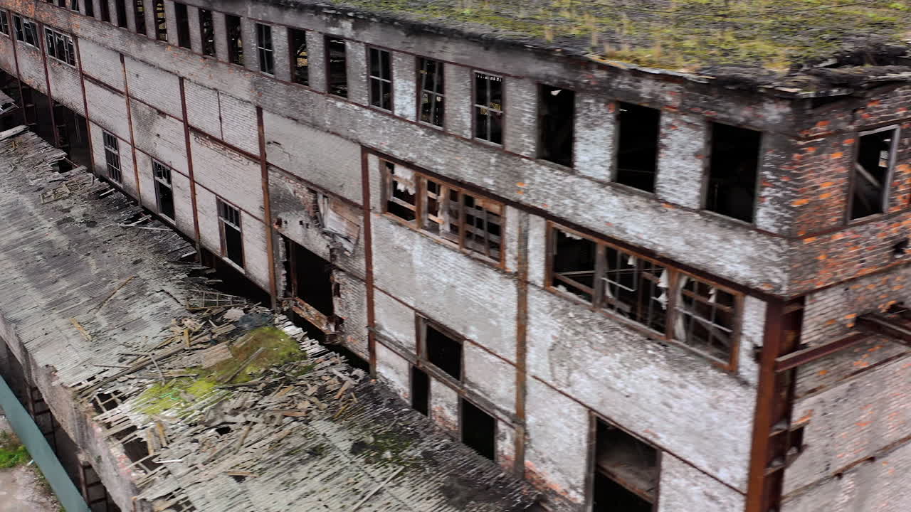 Ruined architecture after military actions. Abandoned building with broken windows and many hole in walls. Damaged building outdoors. Aerial view.