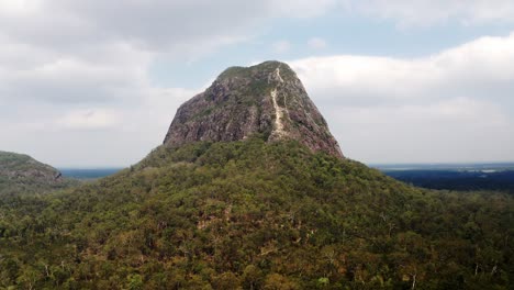 bird's eye view of mountain coonowrin in glass house mountains region in queensland, australia - aerial drone shot