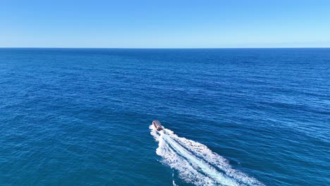 a speedboat cruises through clear blue waters