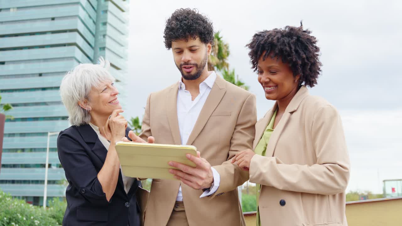 Business People Collaborating with a Tablet Outdoors