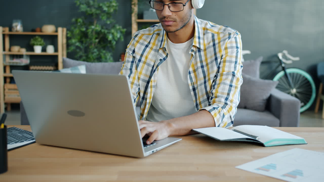 Young Man Studying on Laptop at Home