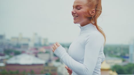 woman running on rooftop in city