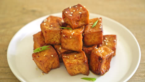 fried tofu with white sesame and teriyaki sauce - vegan and vegetarian food style