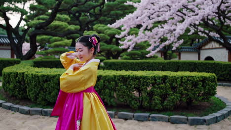 korean girl in hanbok in a spring garden