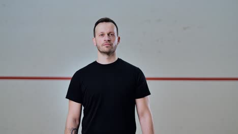 blurry to sharp reveal of man walking into center frame inside empty court