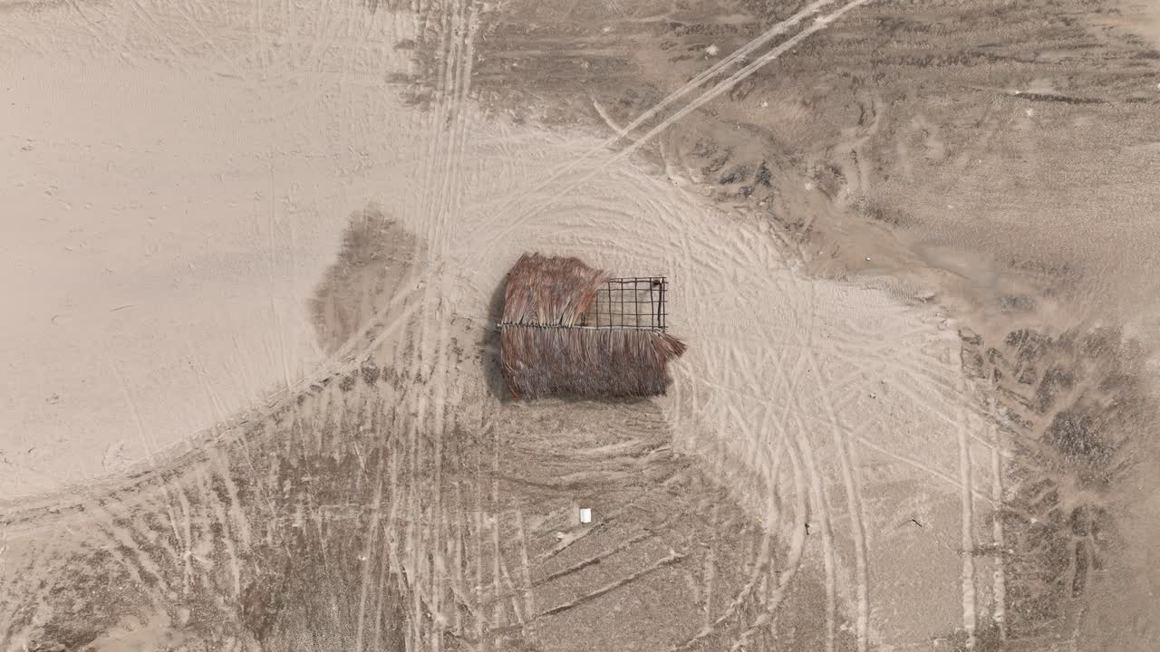 Overhead View Of Thatched Hut With Broken Roof By The River In Parnaiba, Brazil. - aerial ascend shot