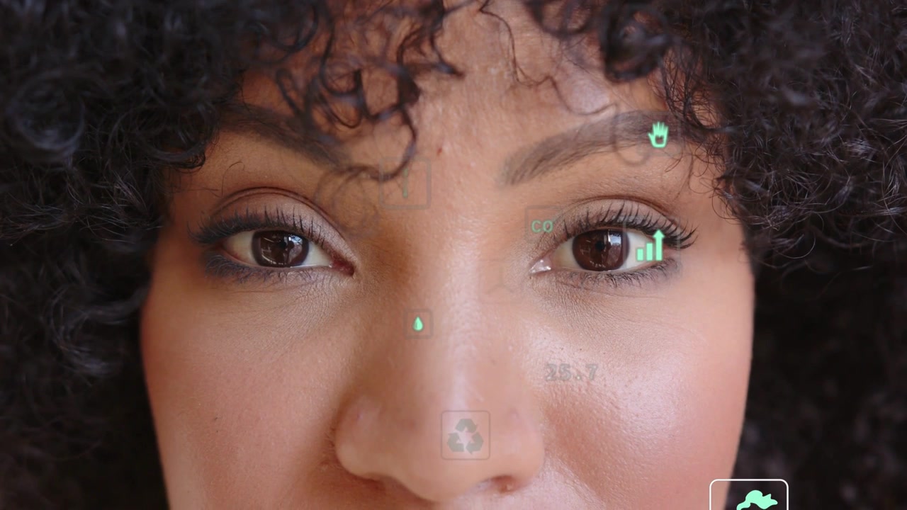 Woman holding gaze while AR system activating and HUD icons showing CO2 and recycling stats