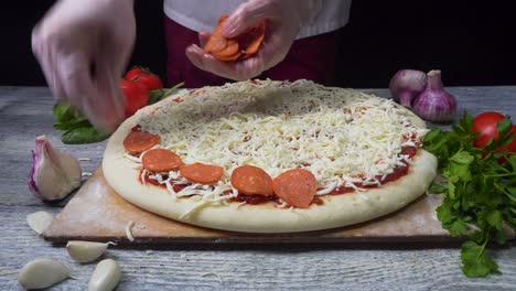 chef preparing a pepperoni pizza