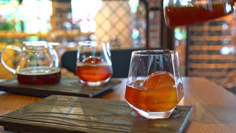 cold drip black coffee jar with glass and ice in coffee shop cafe and restaurant