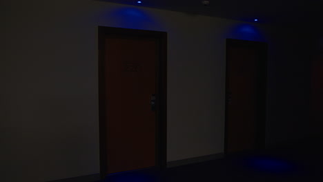 hotel corridor at night with room doors