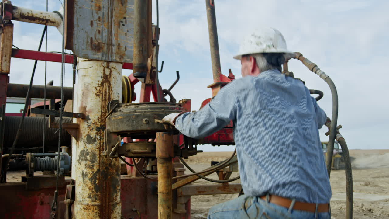 Workers are installing the drilling equipment in the field. Preparation for oil or gas extraction.
