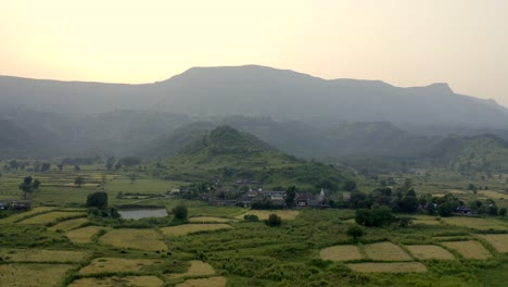 Lush-Hills-and-Agricultural-Fields-in-the-Town-of-Karjat,-India---aerial-drone-shot