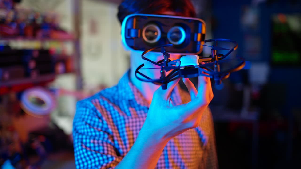 Young engineers with VR virtual reality headset controlling fliying drone in research laboratory, slow motion