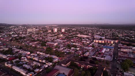 Aerial-orbit-establishing-the-city-of-Temuco-with-the-Llaima-and-Lonquimay-volcanoes,-Chile