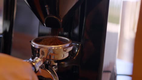 freshly ground cage being prepared for a cappuccino