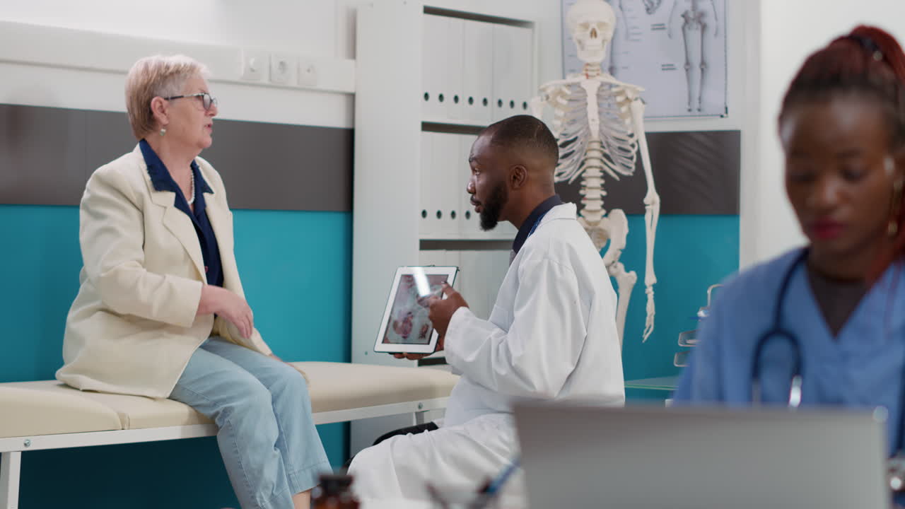Doctor Explaining X-ray to Elderly Patient