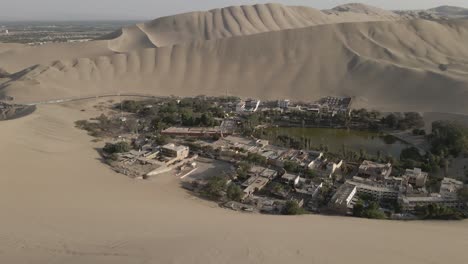 aerial tilt reveals amazing huacachina oasis in desert near ica peru