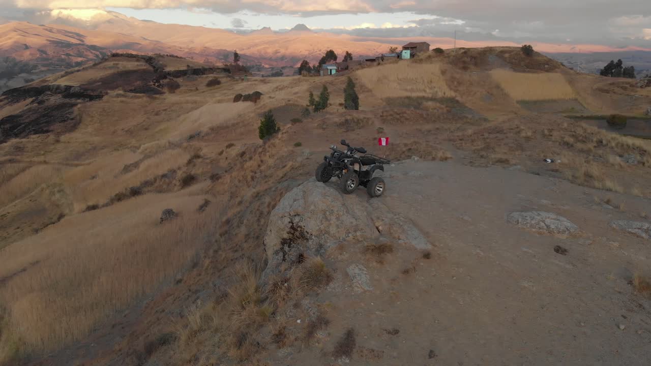 around of the quad, all-terrain, in the andes peruvian flag