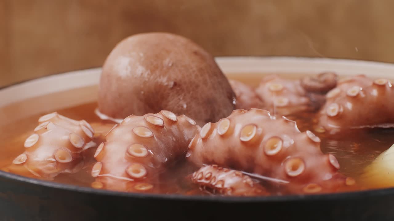 Octopus cooking, chef Boiling fresh octopus on restaurant kitchen, healthy food, seafood cafe in spain, traditional asian japanese spanish and mediterranean dish.