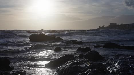 sun shining over the rocky beach in slow motion