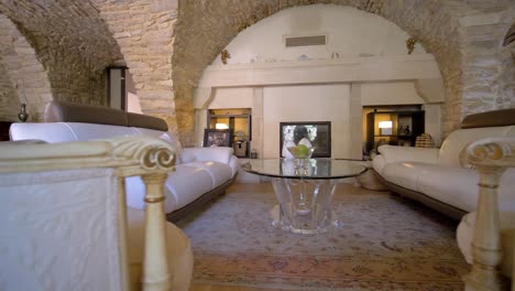 Revealing-shot-of-a-large-open-plan-room-with-stone-archways