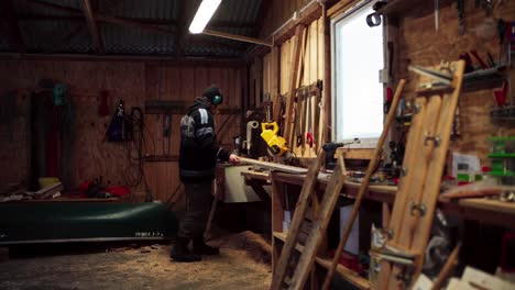 woodworking - man cutting wood planks on a circular saw